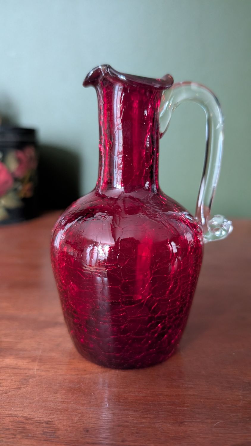 Small red pitcher cracked red glass