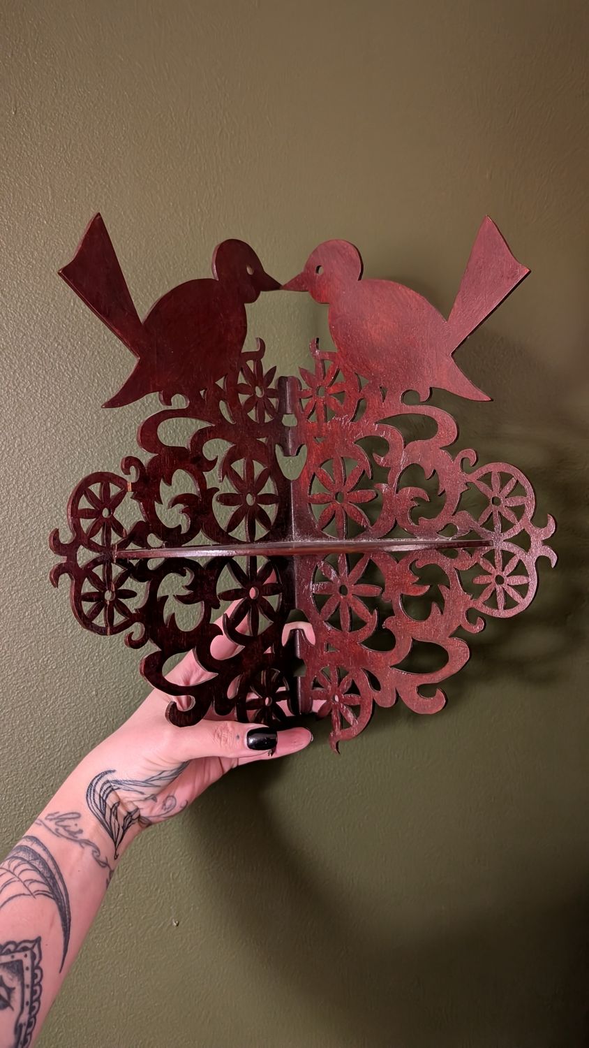 Delicate ornate wooden shelf with birds