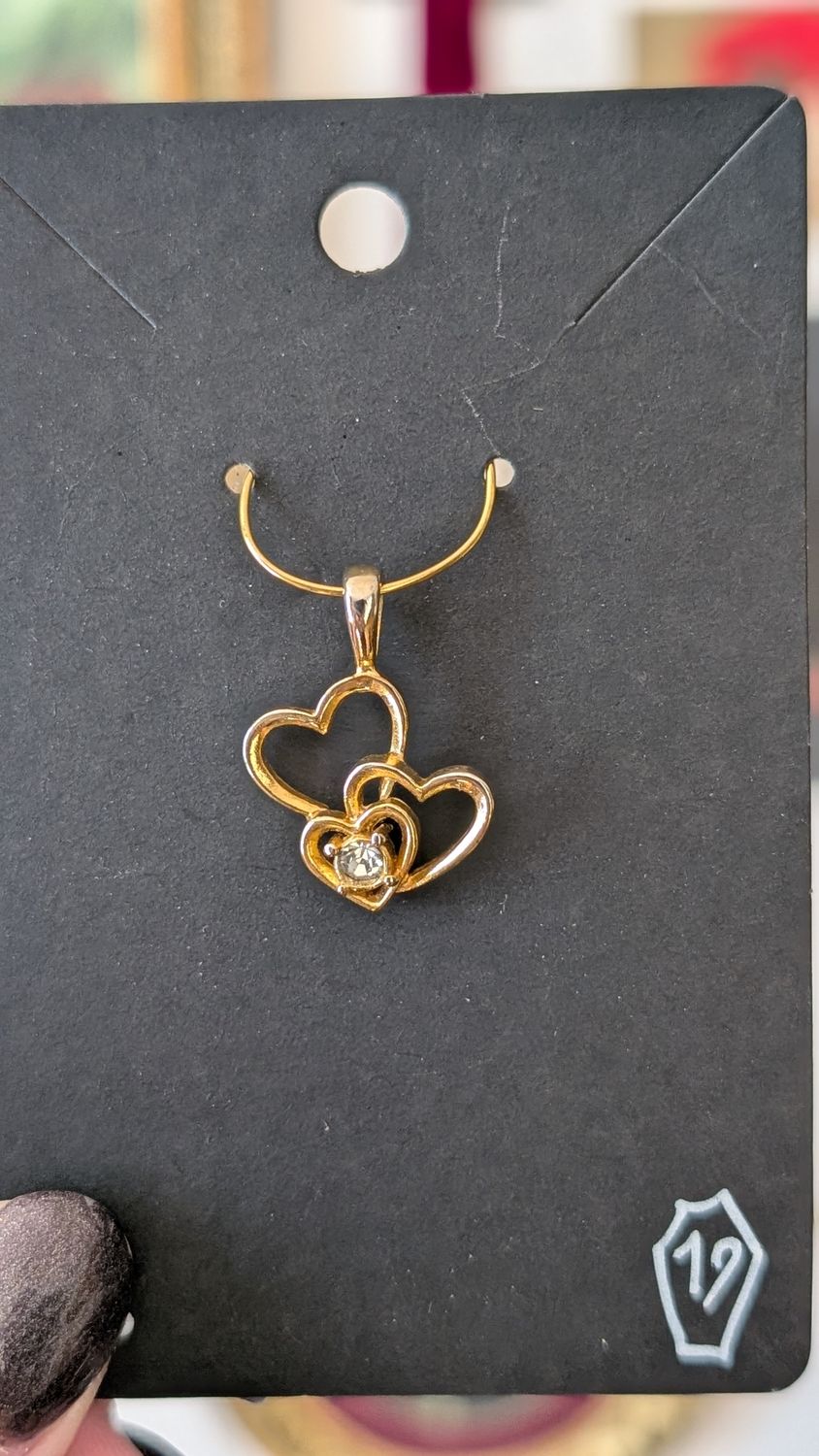 Three hearts gold tone pendant