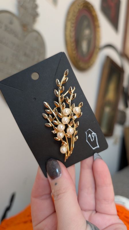 Gold tone floral brooch with faux pearl and clear gems