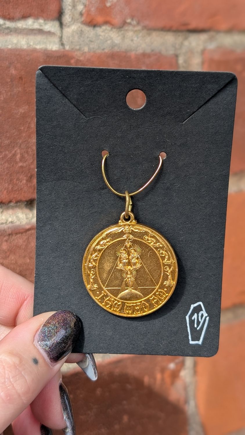 Religious gold tone medal