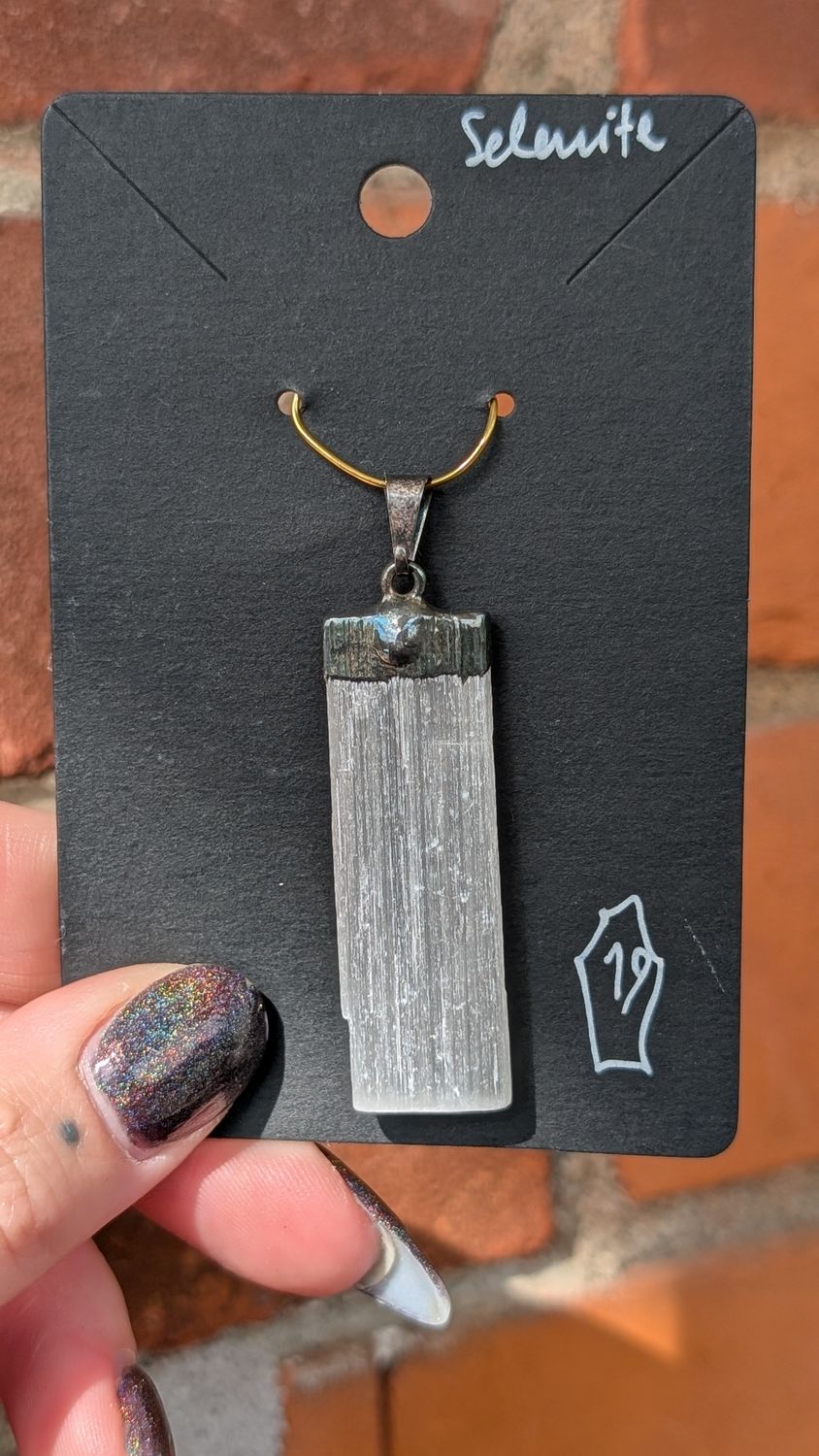 Selenite pendant set in silver tone