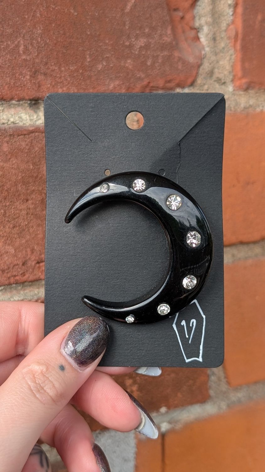 Black plastic moon brooch with clear gems