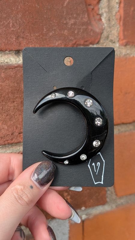 Black plastic moon brooch with clear gems
