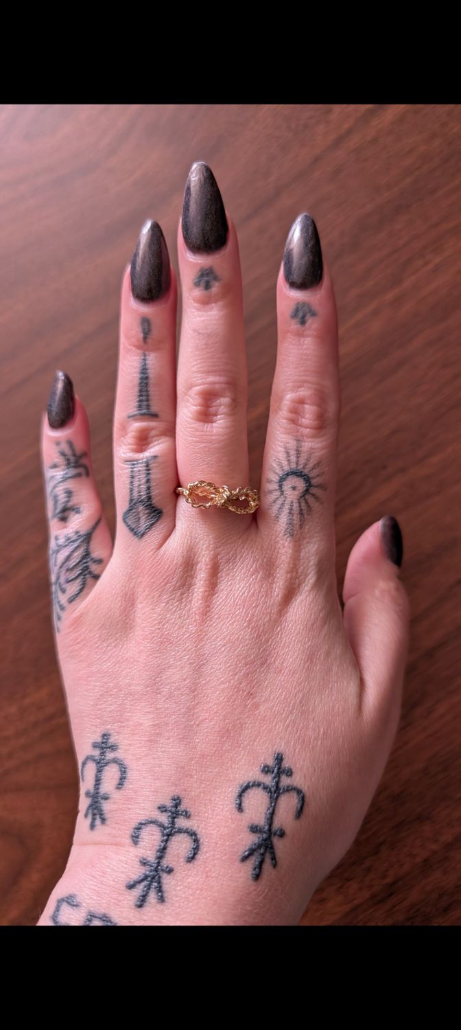 Gold tone bow ring twisted