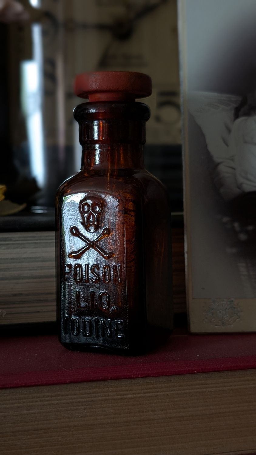 Poison bottle skull head iodine red glass