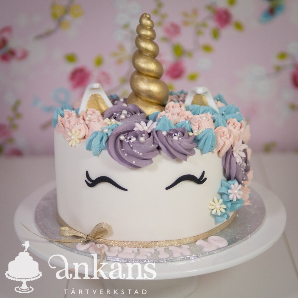 Unicorntårta med horn, man och rosett