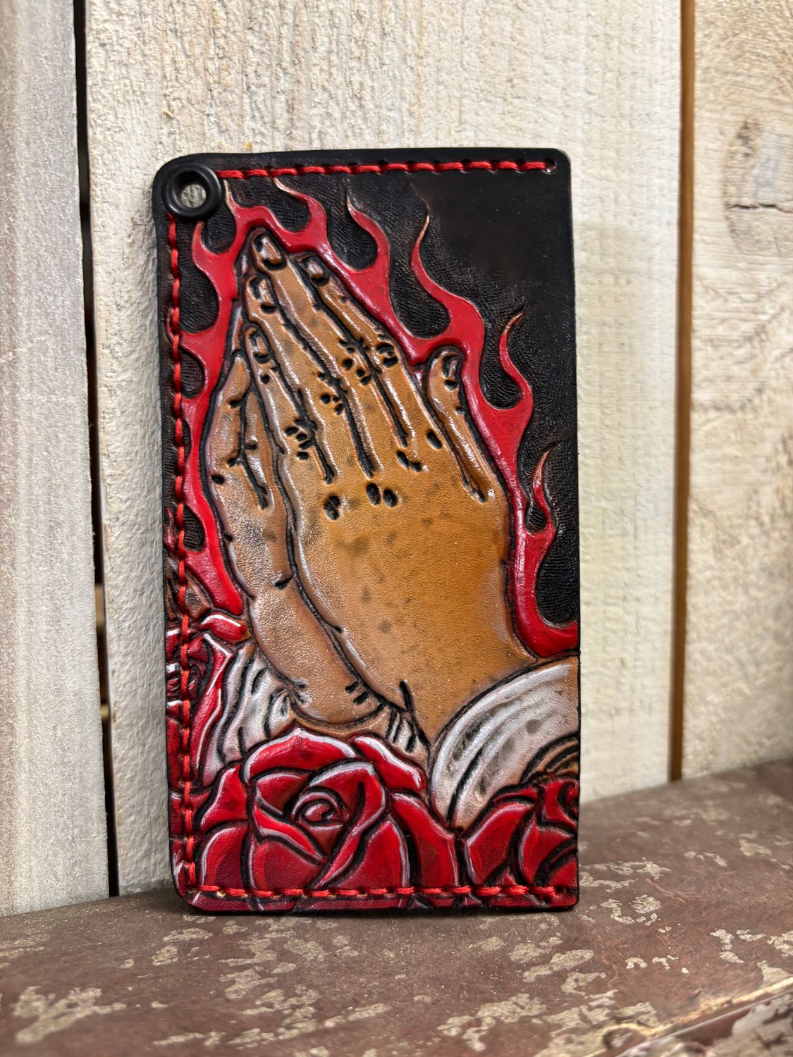 Praying hands with flames