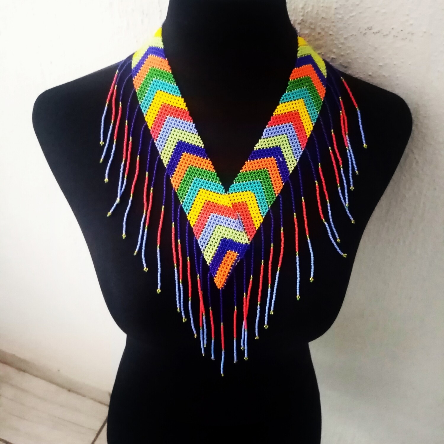 Beaded "V" neck piece with tassel detail