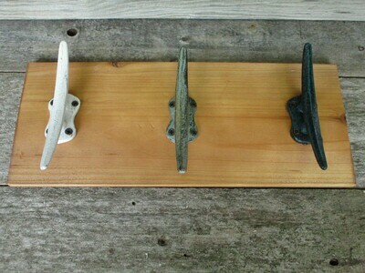 3 CAST IRON CLEAT HOOKS ON WOOD BACKING 3 CAST IRON CLEAT HOOKS ON WOOD BACKING