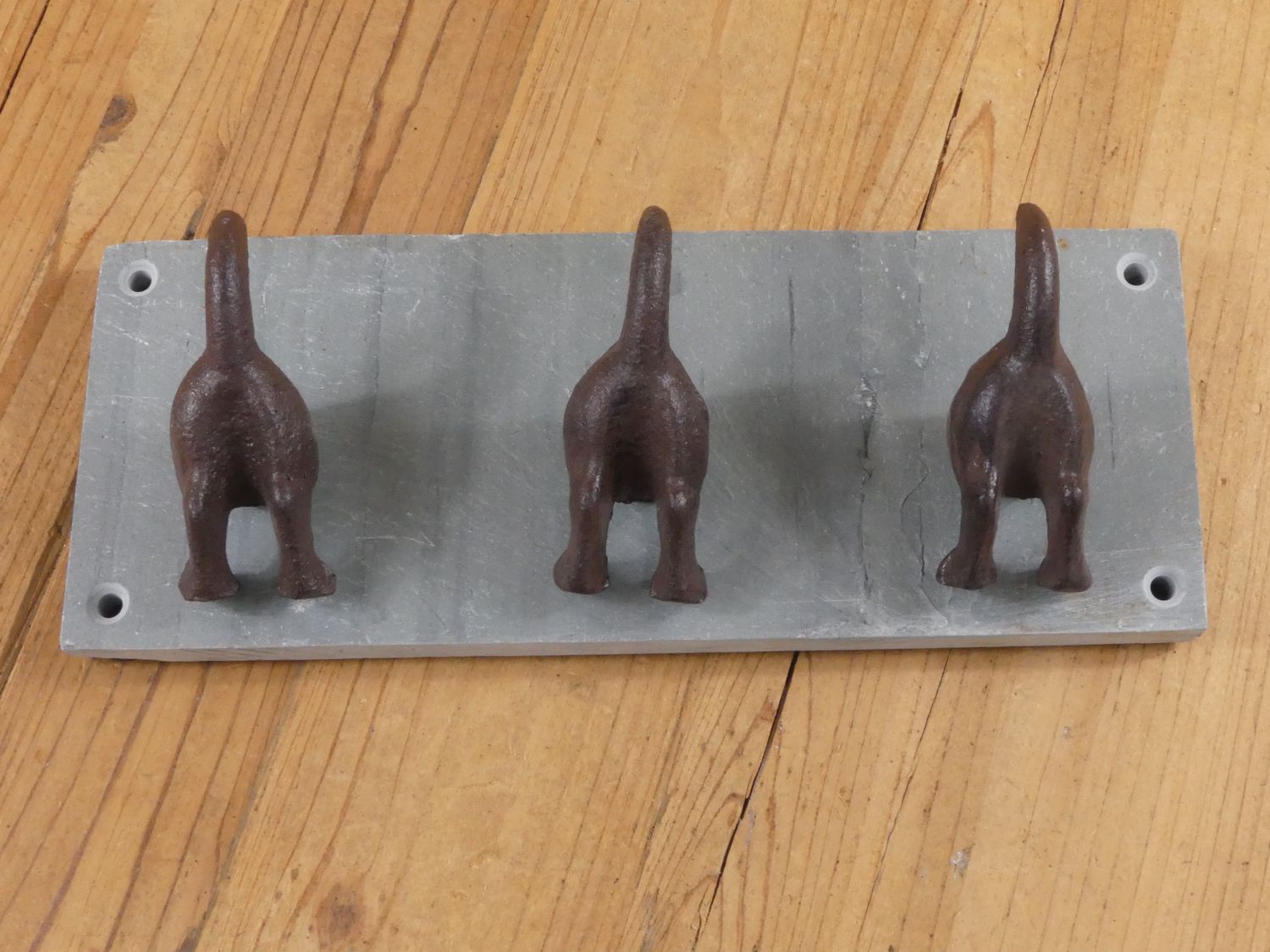 3 DOG TAIL COAT HOOKS ON CAST IRON BACKING