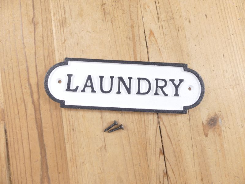 CAST IRON "LAUNDRY" SIGN WITH RAISED LETTERING AND OUTLINE