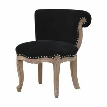 A grand chair with a black velvet fabric and a solid Mango wood in a sunbleach finish.