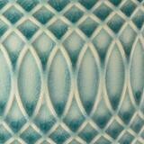 This Morocco pot in a beautiful soft celadon shade features a mesmerising raised geometric pattern. The subtle ridges hold the glaze during firing to create the varying colour intensities to enhance the curves of the design, for a very distinctive finish.
Close up of the pattern