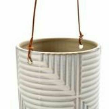 Close up image. A simple white wash glaze allows the grey of the stoneware to peek through, creating a mesmerising intricate design. The planter is waterproof, and a leather hanging cord adds a further contemporary touch.