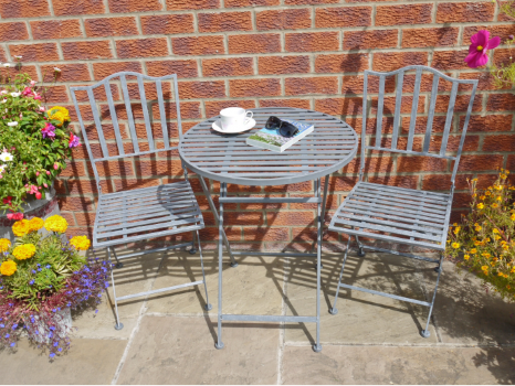The set comprises a lovely round table and two nicely designed matching chairs.