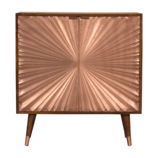 An attractive copper fronted cupboard having a sunray-type design