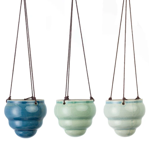 Three small hanging pots.
Blue, green and light green
