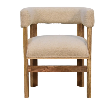 This boucle chair is so trendy at present. This chair has been hand crafted in solid mango wood, in an oak finish and a soft comfortable cream boucle seat pad, and boucle back and arm rests.