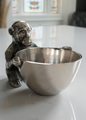 The bowl is supervised by this little monkey!