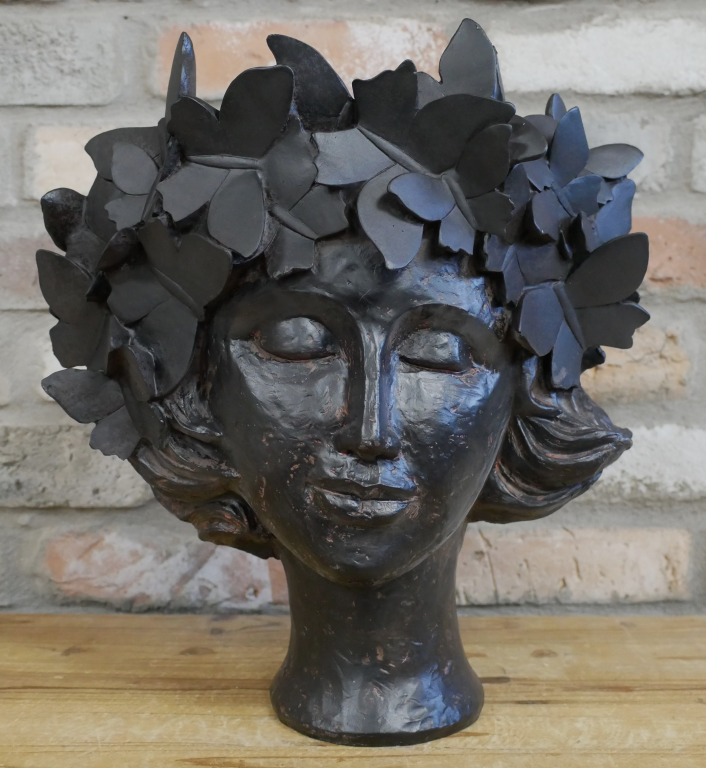 Josephina Black Finish Head Planted. 
She has closed eyes and ivy wreath - completely finished in black.
Sited against a brick wall and on a wooden surface