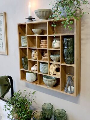 Here is one that has been wall mounted with a collection of pottery