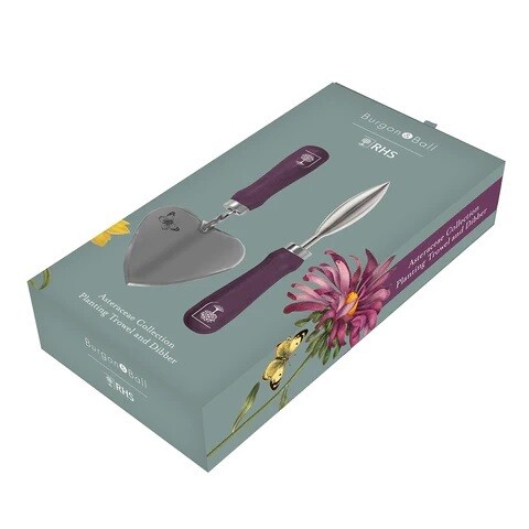 Asteraceae Design. Light Duck Egg Blue with three yellow flowers and one purple flower design.
Gift box featuring an image of contents - purple handled trowel and dibber