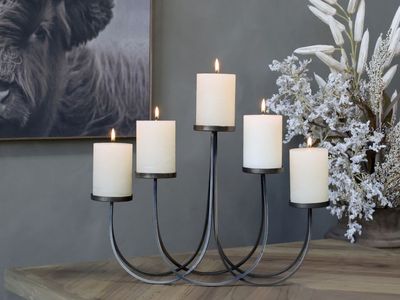 Elle Candelabra
Metal finish - Antique Brass
Loop design with five holders and three levels
Dressed with candles on a worktop