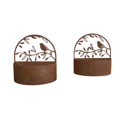 A pair of rusty finish plant holders for wall mounting with bird and leaf decoration.