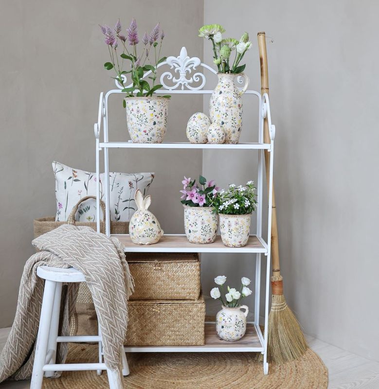 Chatilon Shelving Unit
White metal framed, French decor inspired, with wooden shelves. Three shelves.
Image shows the shelving unit dressed with vases and storage containers. Against a small french white stool and throw.