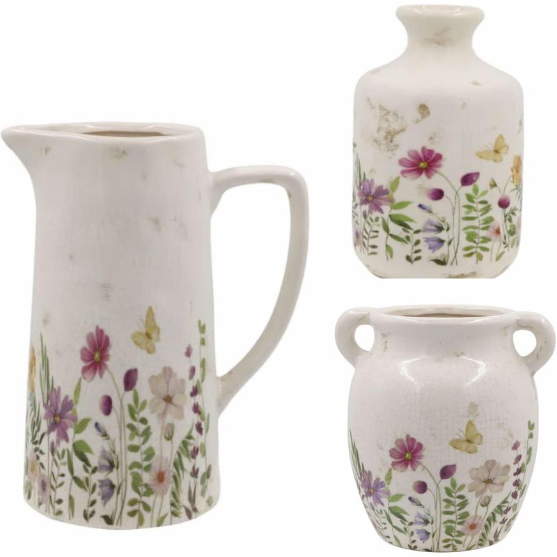 An absolutely beautiful range of chinaware with a wild flower design.This image is the complete set of water jug, bottle and pretty vase all in this design and available as a complete set. 
The set has a cream finish.