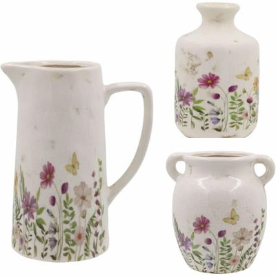 An absolutely beautiful range of chinaware with a wild flower design.This image is the complete set of water jug, bottle and pretty vase all in this design and available as a complete set. 
The set has a cream finish.