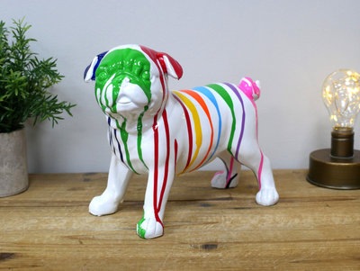 Front face view.
A lovely resin cast boxer dog in perfect clear white, with dripping paint stripes in a myriad of colours. 
Full view of dog standing on a shelf.