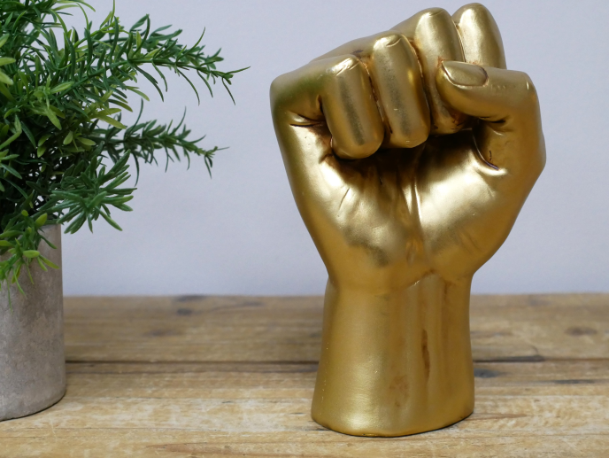 Golden fist statue.
Made from resin.
Front palm view on shelf
Small fist is 17 cm tall
Large fist is 22 cm tall