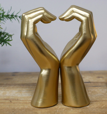 Golden ornament 16 cm tall.
Front view on shelf, Two hands together making heart shape.
Made from resin.
16 cm tall 