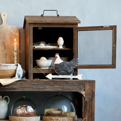 In days gone by, this is where a well-off family would store their meat before it was consumed. These days, we have a fridge or freezer for that, but this lovely replica can be used for many types of food storage, and they are in vogue in the very best of kitchens.
Image shows open door and inside view.
Our meat safe is made from recycled wood, and MDF. 
Dimensions 42 x 52 x 34 cm