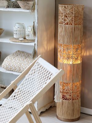 This natural wicker floor lamp is just as impressive as you'd expect it to be! Shown here in a room setting,
the light from this floor lamp gives a warm diffused glow that will give you a comfortable relaxing evening.
It's 127 cm high and made of raffia and has an iron frame
