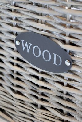 Set of two log baskets each with a handle for easy carrying and an open end for longer logs. Made from willow and a natural colour finish. This view shows the 'WOOD' label that adorns each of the log holders.
Height is 51 cm and 49 cm long.