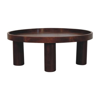 A very handsome coffee table crafted in sturdy mango wood, in a chestnut shade finish.
It has a generous 80 cm diameter and stands 31 cm off the floor. 
A useful feature is the raised tabletop edge that makes clumsy accidents a thing of the past.
