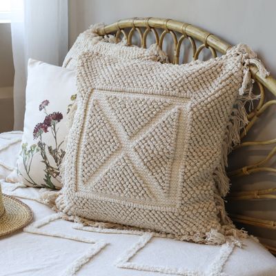 Square Cushion with Fringing and Mesh Fabric Finish.  Central Square and Cross Design.
Set on a bed with matching Bedspread