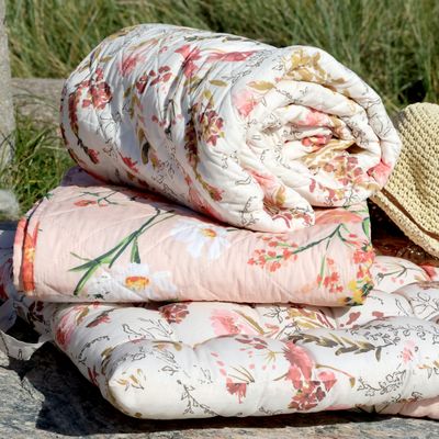 Chic Quilt with Peach Flowers on Pale Rose Background
Folded and Stacked in Pile