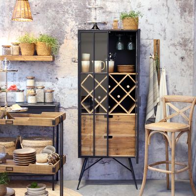 A tall industrial-style drinks cabinet with a black metal frame, glass-panelled double doors, an internal wooden diamond wine