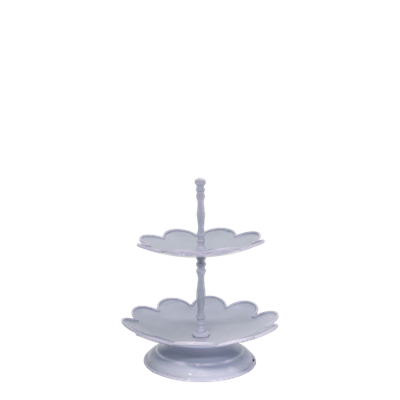 Two-tier white ceramic serving stand holding grapes and sliced fruit, styled on a rustic kitchen table with bread and plates 