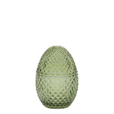 Small decorative green glass container with a diamond-cut texture and a rounded lid, shaped like an egg