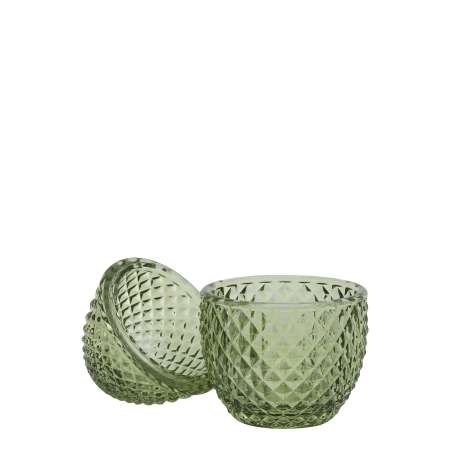 Small decorative green glass container with a diamond-cut texture and a rounded lid, shaped like an egg. Shown open in half.