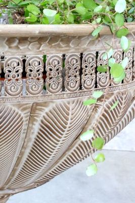 Decorative metal bowl with engraved patterns, side handles, and a pedestal base
