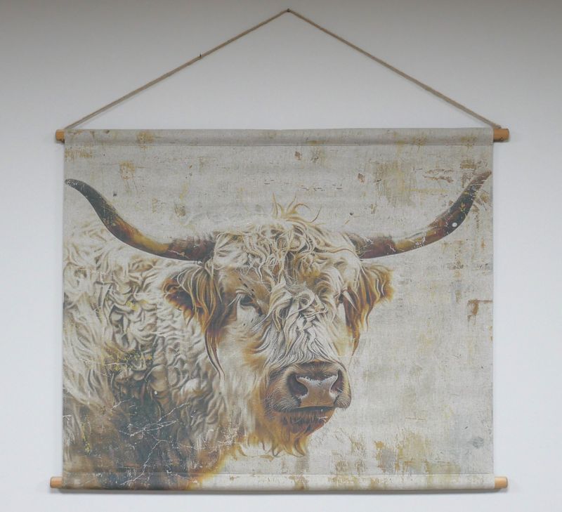 Fabric wall hanging showing a painted Highland cow with long curved horns and shaggy fur on a textured neutral background.