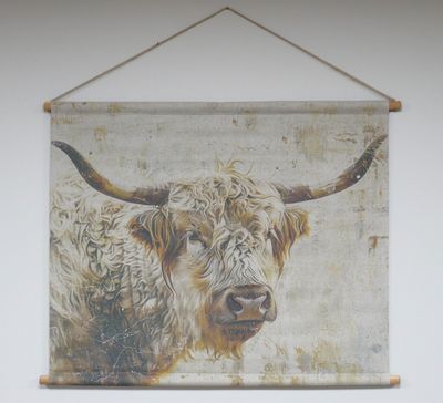 Fabric wall hanging showing a painted Highland cow with long curved horns and shaggy fur on a textured neutral background.