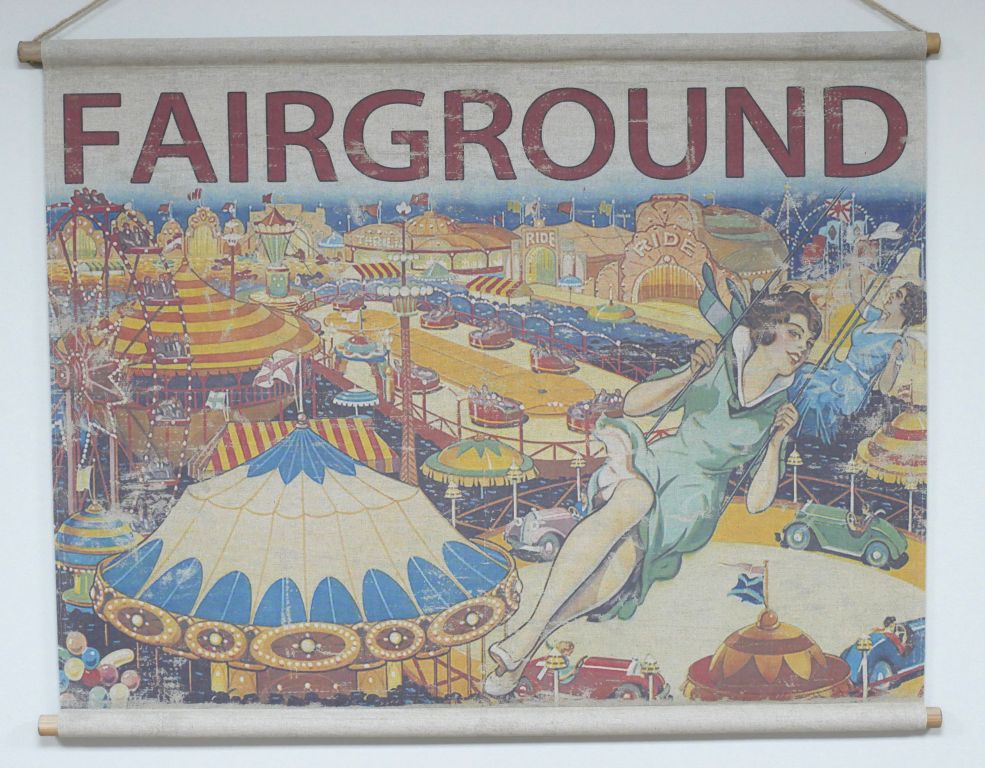 Fabric wall hanging showing a vintage fairground scene with rides, tents, and figures, topped with the word “FAIRGROUND”