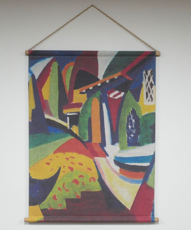 Fabric wall hanging showing a colourful abstract design with bold shapes and contrasting tones, printed on textured fabric.